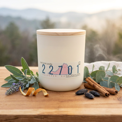 22701 13 oz candle styled with scent-inspired botanicals in a woodland setting