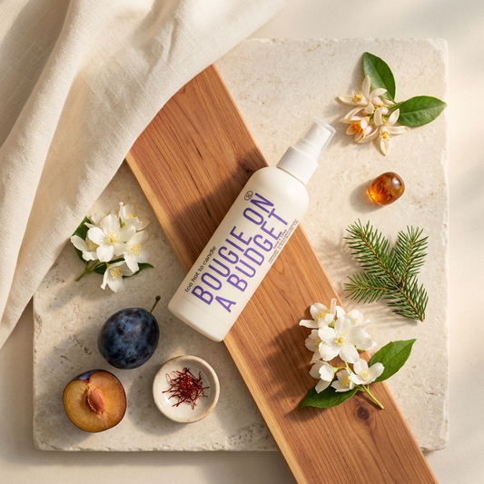 Bougie on a Budget Spray overhead flat lay with jasmine, saffron, and warm cedar styling