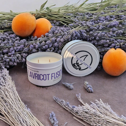 Too Hot To Candle Lavricot Fusion scented candle in a white tin with lavender, apricots, and dried lavender sprigs.